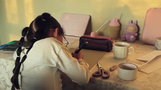 Colombian schoolgirl writing homework at creative study desk in golden afternoon light before back to school season