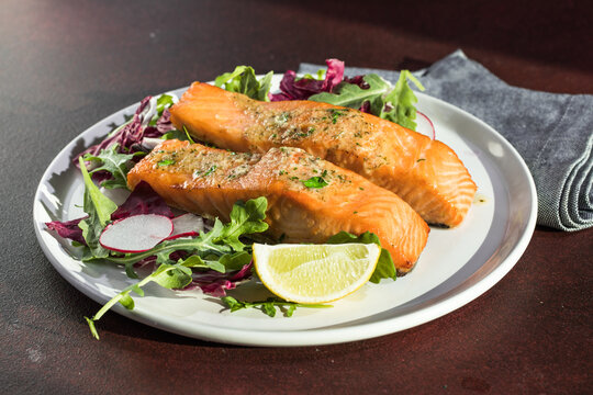 Salmon. Fried salmon steak with red radicchio cabbage, radish and arugula.