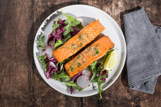 Salmon. Fried salmon steak with red radicchio cabbage, radish and arugula.