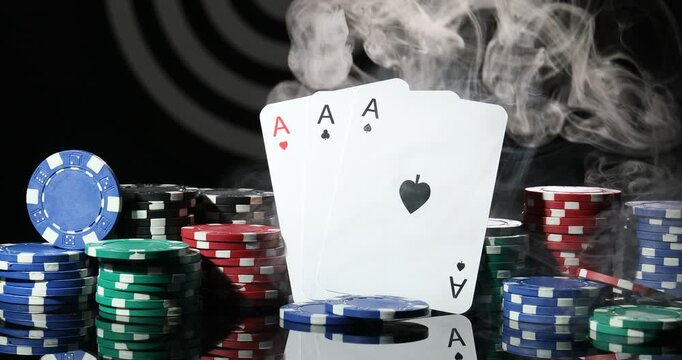 Playing cards and casino chips in smoke on black mirror table, closeup