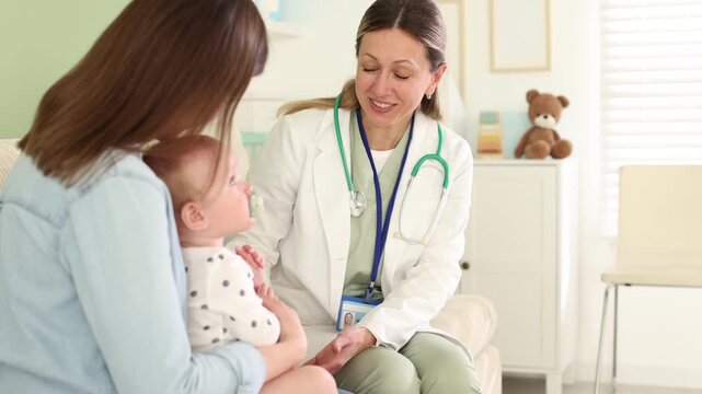 Mother and her baby having appointment with pediatrician in hospital, camera moving in
