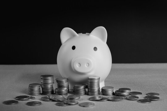 Piggy bank with stack of coins on black background. saving money , investment, finance planing. 