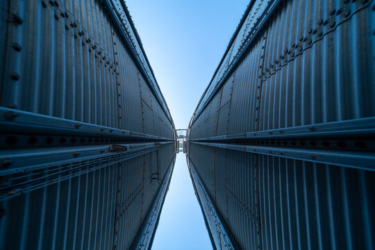 Two massive industrial silos at a farm facility