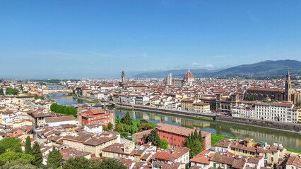 Fototapeta premium Aerial drone view Florence Lungarni Arno River banks with historic buildings colorful facades Ponte Vecchio and Tuscan cityscape