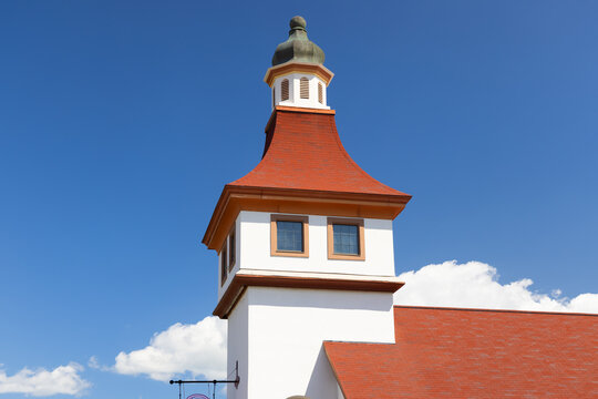 Building tower with red roof under blue sky
