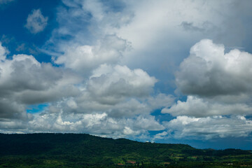 Obraz premium Amazing landscape fog mountain clouds scenery. Beautiful Mountain landscape foggy windy mountain range green landscape asian farm. Landscape mountain green field meadow white cloud blue sky sunrise