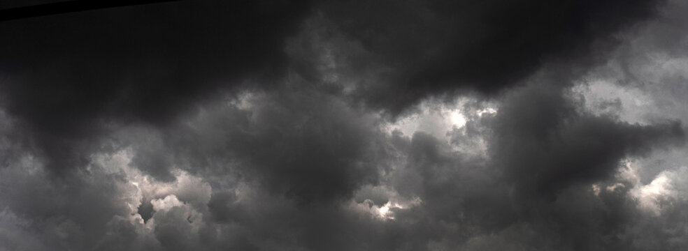 Banner Dramatic Dark thunderstorm clouds rainny season. Dark cloudscape storm cloud with copy space. . Panorama Meteorology danger windstorm disasters climate. dark storm clouds black sky background