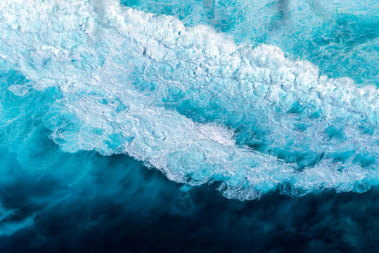 Banner Blue ocean Turquoise sea water white foam wave pattern splashing deep blue sea. Banner Tropical sea beach Seascape dark background splash on rock. Summer Ocean Surface wave with copy space