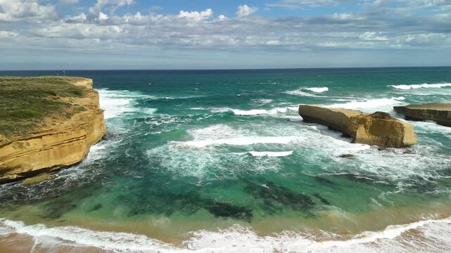 Sherbrook River Beach, Great Ocean Road, Port Campbell, Victoria: 4K aerial drone footage of river mouth, sandy beach, coastline and coastal cliffs near Thunder Cave and Mutton Bird Island