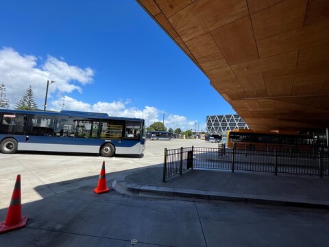 Auckland Transport AT Metro Airport Link bus parked at Puhinui Station transport hub under a clear blue sky in Otara-Papatoetoe - Auckland, New Zealand, February 7, 2023