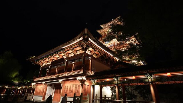 Traditional Chinese temple with flying eaves and dougong brackets illuminated by night lighting