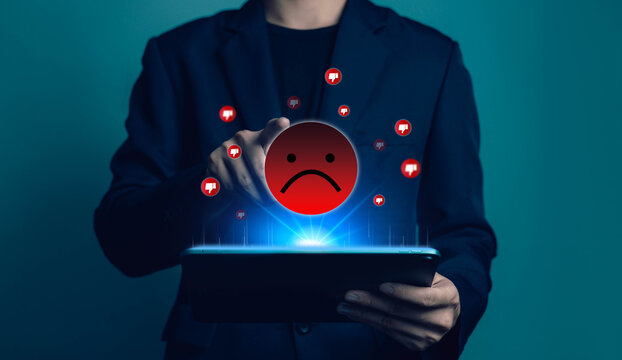 Negative customer experience and online dislike feedback concept with sad face icon and dislike symbols above tablet, poor service review, client dissatisfaction and bad user satisfaction rating