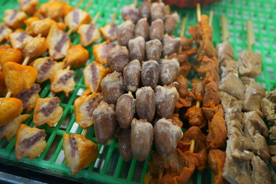 Raw chicken offal skewers on display at a Taiwanese food stall.
