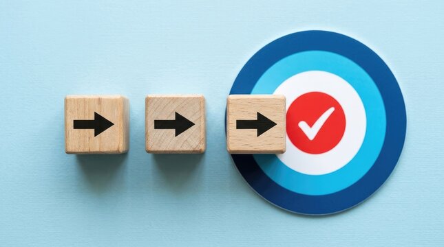 Three wooden blocks with black arrows pointing towards a target with a checkmark cube