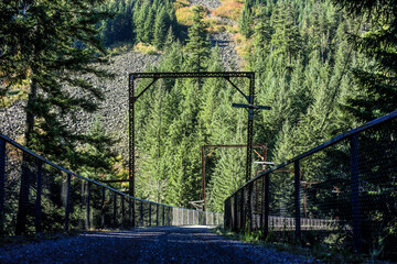 Gravel Trail Crossing a Historic High Bridge with Industrial Steel Gantry Frames in the Cascade Mountains © Nick