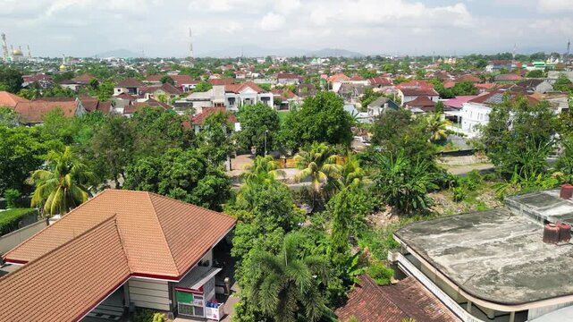 Drone perspective of Mataram showing cityscape, buildings, and surrounding tropical scenery