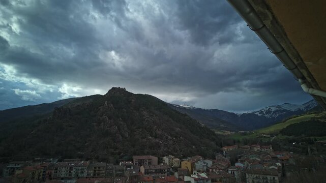 Ominous storm clouds sweeping across the sky in a dramatic timelapse over the mountain village of Ribes de Freser, located in the scenic Catalan Pyrenees of Gerona, Spain