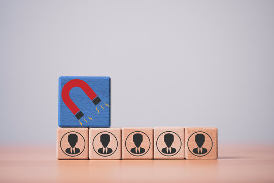 Customer attraction and lead generation concept with magnet icon above business people blocks, representing recruitment, marketing strategy, talent acquisition and audience targeting