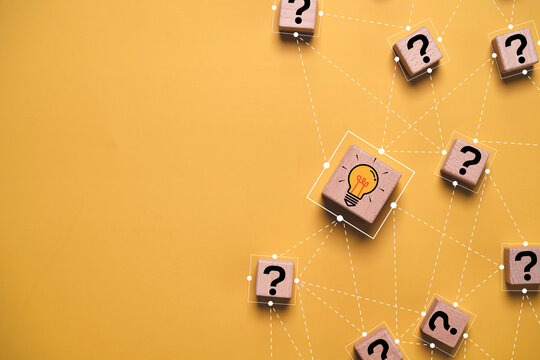 Creative problem solving and idea connection concept with linked question mark blocks and glowing light bulb, representing innovation, brainstorming, networking, strategy and business solutions