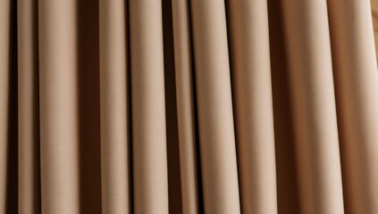 Obraz premium Rich beige fabric curtains with deep vertical folds and textured surface creating elegant drapery and soft shadows
