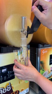 Orange Slushie Being Poured From a Frozen Beverage Dispenser Machine