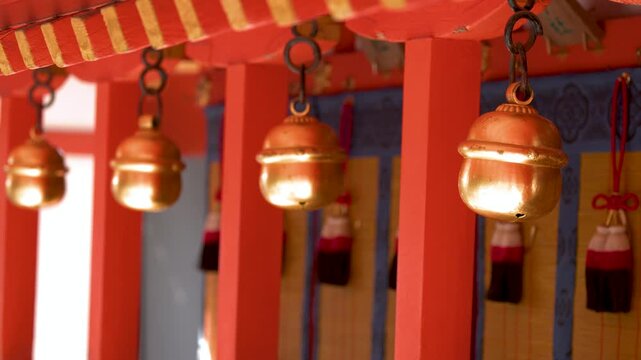Traditional Brass Suzu Bells Hanging at a Shinto Shrine in Kyoto