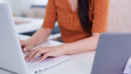 Fototapeta premium Asian women typing laptop computer hands keyboard working from home office hybrid work remote worker professional businesswoman online freelancer digital