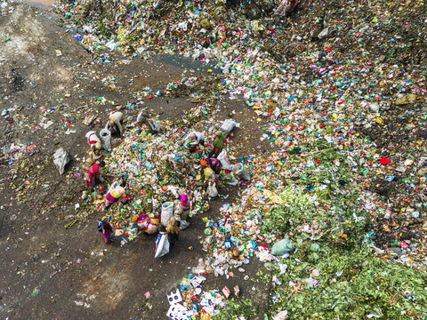 Aminbazar, Bangladesh - 26 January 2025: Aerial view of waste pickers sorting through colorful plastic and organic garbage at the Aminbazar landfill.