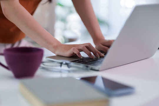businesswoman hands typing laptop computer keyboard remote work from home office desk hybrid working professional female employee browsing internet online