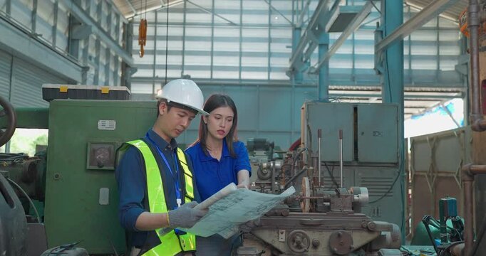 Engineer Reviews Technical Drawing With Startup Entrepreneur in Small Lab Workshop