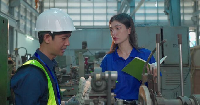 Engineer Reviews Technical Drawing With Startup Entrepreneur in Small Lab Workshop