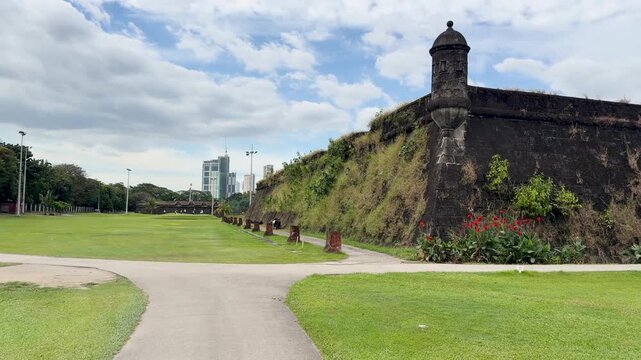 Filipino Golf Caddy Walking Along a Path at a Manila Golf Course
