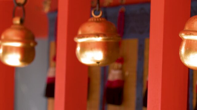 Traditional Brass Suzu Bells Hanging at a Shinto Shrine in Kyoto