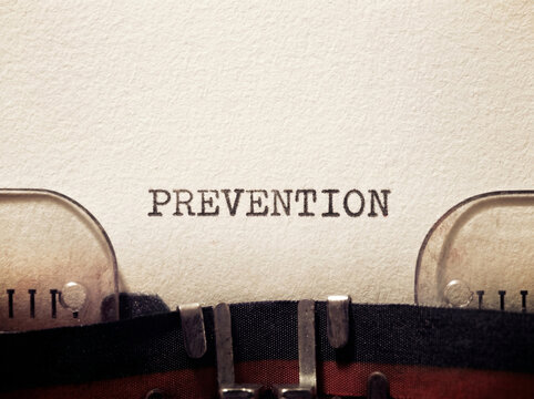 The word "Prevention" written on a typewriter. Concept of prevention against sexual and mental illnesses, men's and women's health.