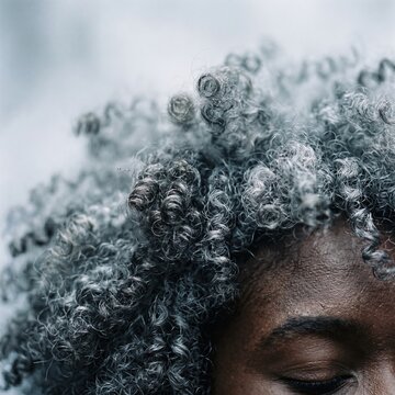 Natural afro hair curls captured in a tight macro landscape composition for beauty editorial, hair care advertising and abstract with copy space