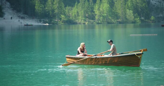 Couple enjoying a boat ride on Lago Di Braies, Italy