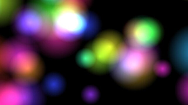 Animated motion graphic featuring abstract, soft-focus colored bokeh lights drifting and pulsing gently against a dark background.