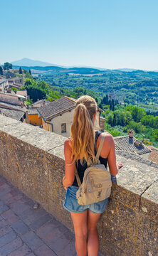 young woman traveler contemplating the timeless panorama of montepulciano