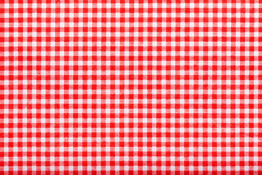 above of placemat fabric cloth or arrangement of gingham-patterned red fabrics background. food decoration menu design.