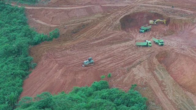 The process of unloading soil in road construction, a truck is loading soil into the truck bed