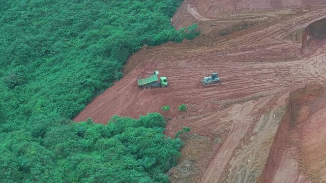 The process of unloading soil in road construction, a truck is loading soil into the truck bed
