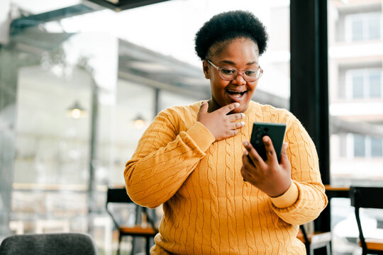 Joyful woman reacting to exciting news on smartphone