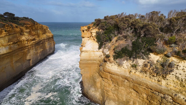 Aerial View of Waves Crashing Between Sandstone Cliffs at Loch Ard Gorge