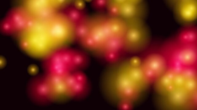 This abstract motion background features softly glowing, out-of-focus red and yellow orbs against a dark backdrop, creating a bokeh effect.
