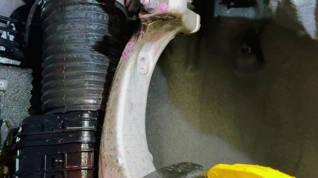 The process of washing the suspension, the underbody of the car with a chemical composition and a brush at the car wash. Washing the suspension of the car from reagents and contaminants using brush.  