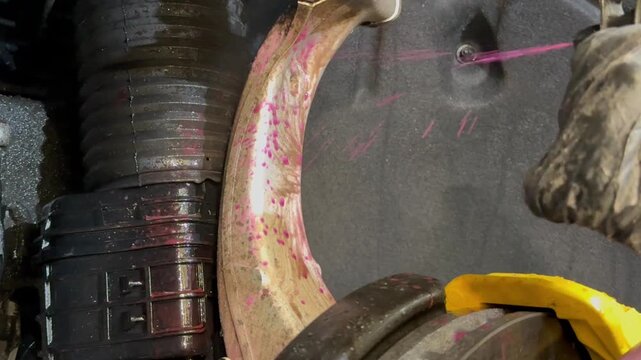 The process of washing the suspension, the underbody of the car with a chemical composition and a brush at the car wash. Washing the suspension of the car from reagents and contaminants using brush.  