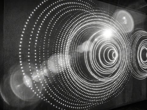 Mesmerizing abstract pattern of glowing concentric dots forming intricate circular waves on a dark background, evoking a sense of digital technology and light