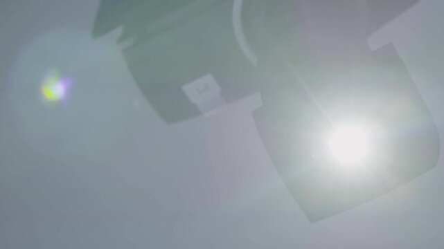 Stage spotlight emits bright beam and haze in a controlled indoor lighting setup