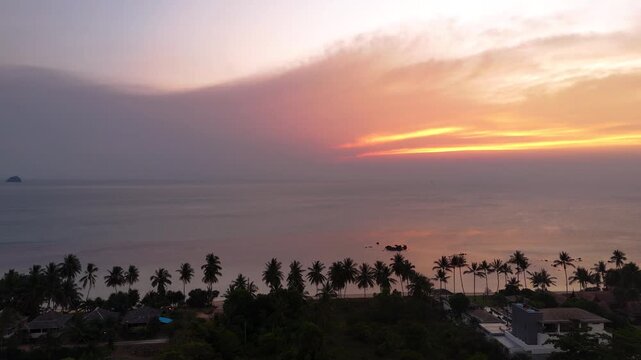 Fly towards sea at Taling Ngam beach during sunset