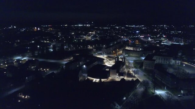Epic long duration night aerial panorama showing illuminated Rakvere city and skyline.